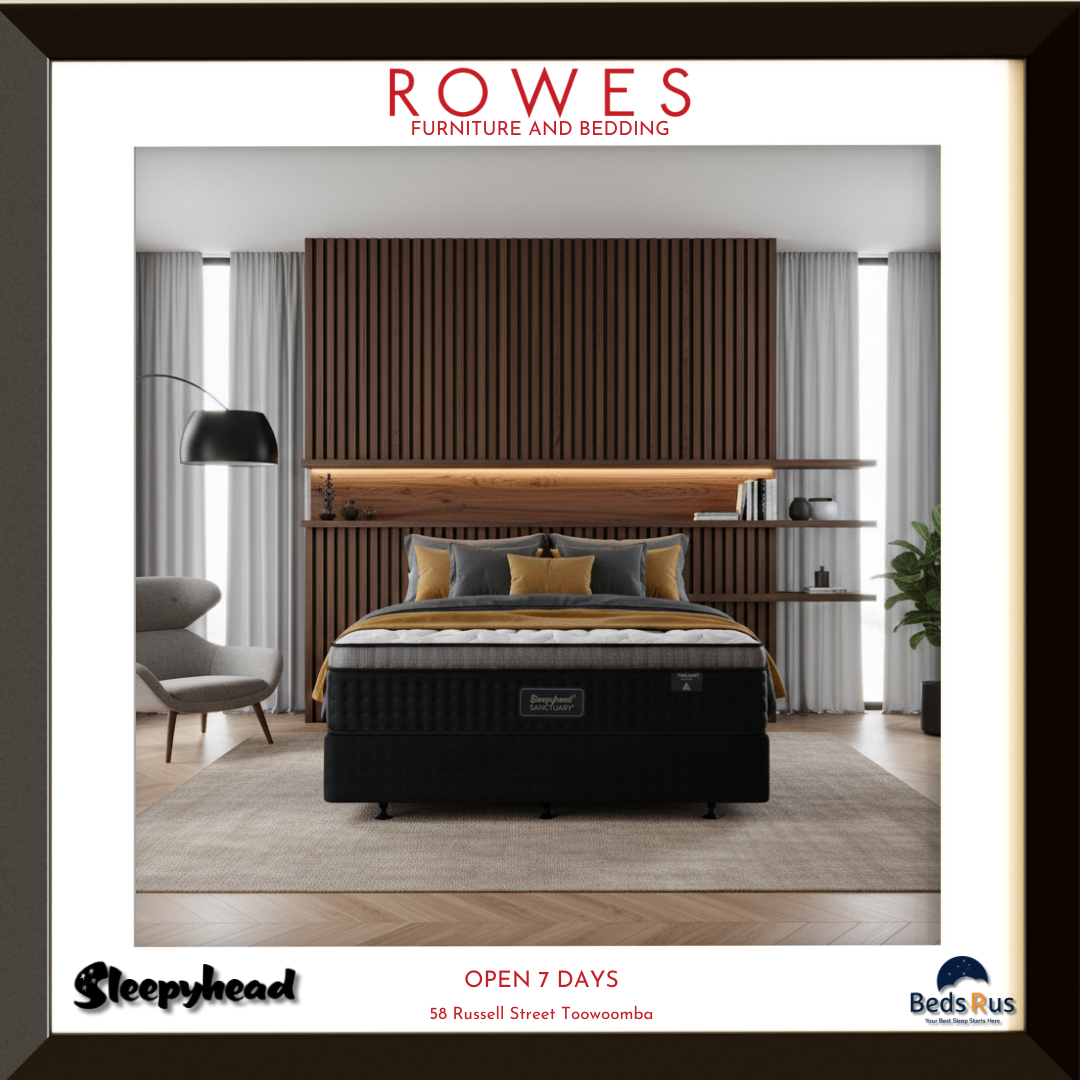 Bedroom scene with a black mattress, wooden headboard, and 'Rowes Furniture and Bedding' branding.