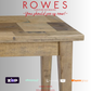 Wooden table with 'Rowes Furniture and Bedding' advertisement on a white background