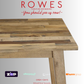 Wooden table with promotional text and logos on a white background