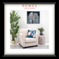 Furniture and bedding advertisement featuring a cream armchair with a floral pillow, potted plant, and side table.