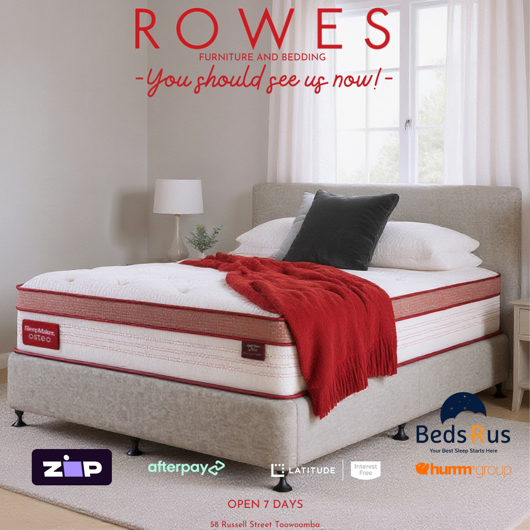 Mattress with red blanket and pillows on a bed in a room, featuring 'Rowes Furniture and Bedding' advertisement.