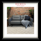 Gray sectional sofa with a blanket and pillow against a brick wall, featuring 'Rowes Furniture & Bedding' branding.