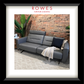Gray sofa with a blanket and pillow against a brick wall, featuring 'Rowes Furniture & Bedding' logo.