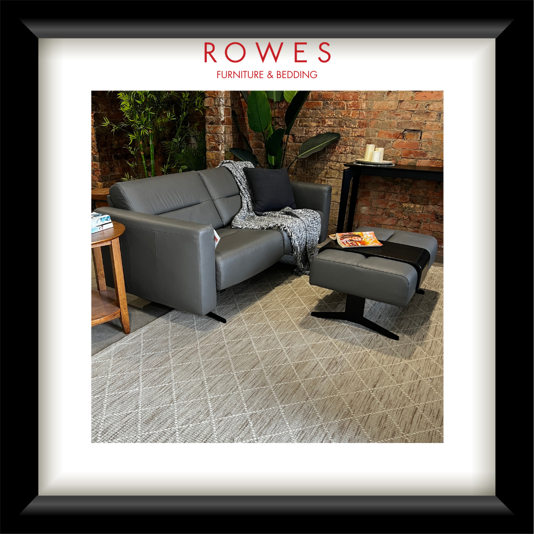 Gray sofa and ottoman in a living room setting with 'Rowes Furniture & Bedding' branding.