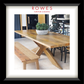 Wooden dining table with bench and potted plant in a room setting, featuring 'Rowes Furniture & Bedding' logo.