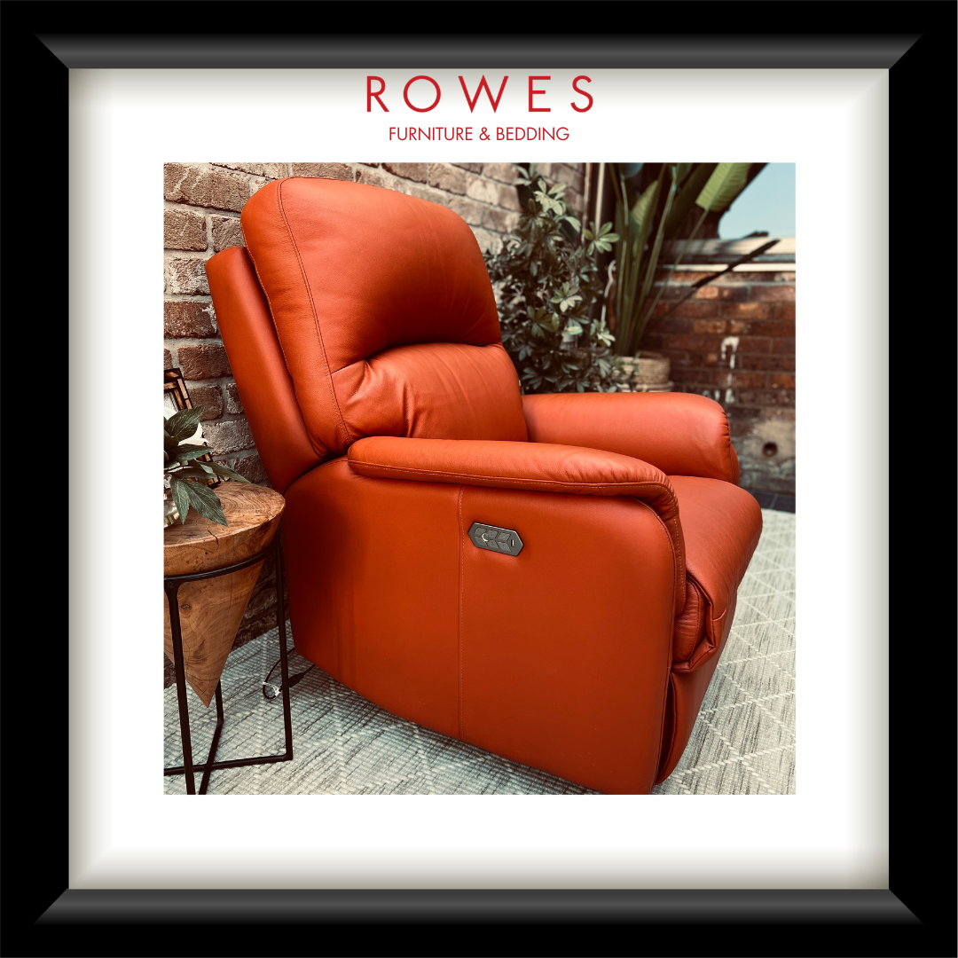 Orange recliner chair in an outdoor setting with 'Rowes Furniture & Bedding' branding.