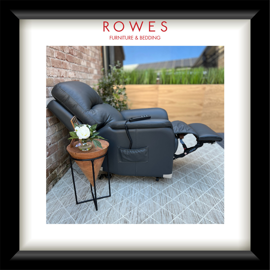 Gray recliner chair with a small table and plant on a patio, branded 'Rowes Furniture & Bedding'.