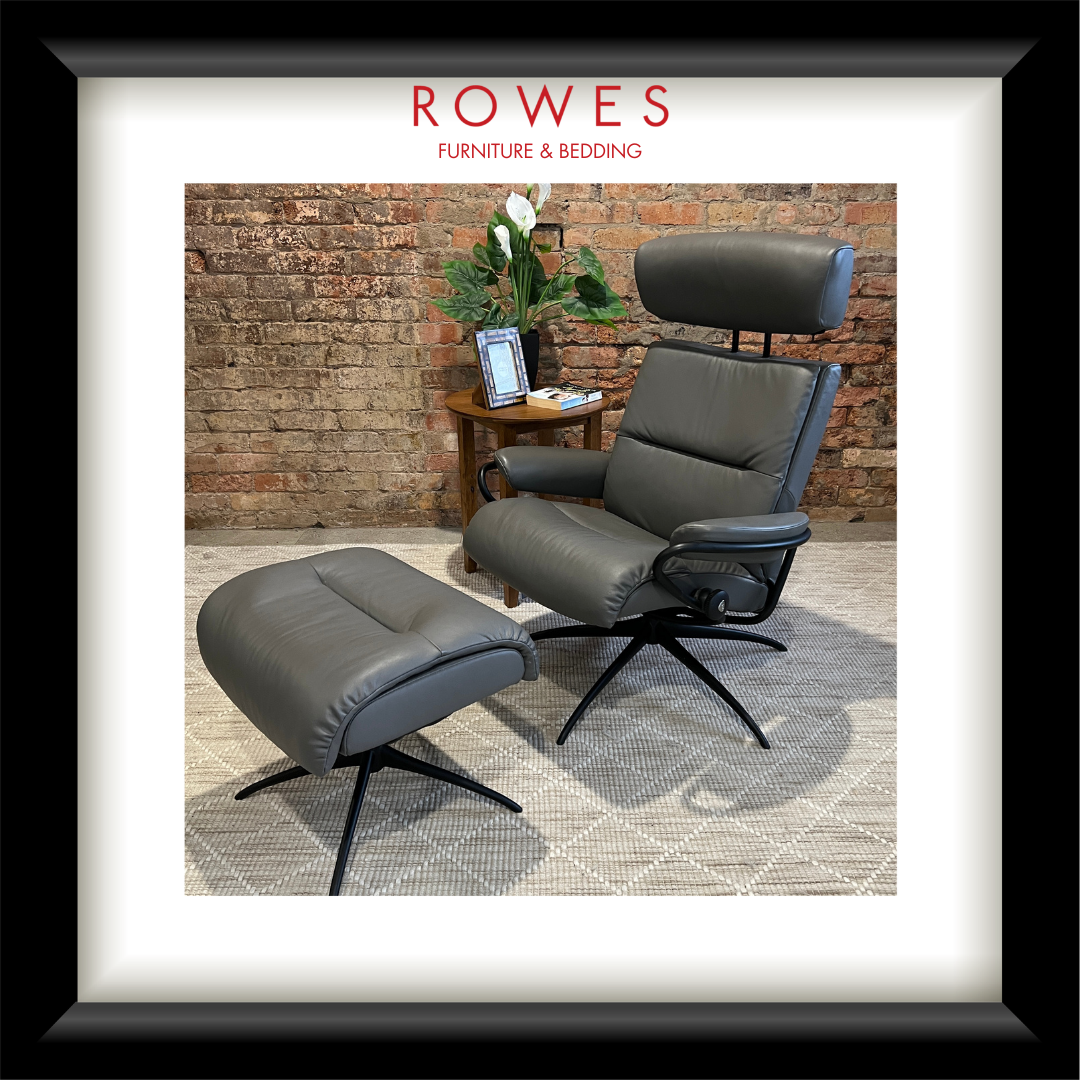 Gray armchair and ottoman with a brick wall background, featuring Rowes Furniture & Bedding logo.