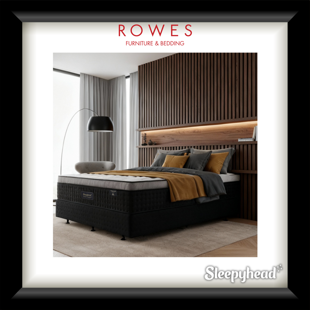 Bedroom setup with a mattress and bedding, featuring Rowes Furniture and Bedding branding.