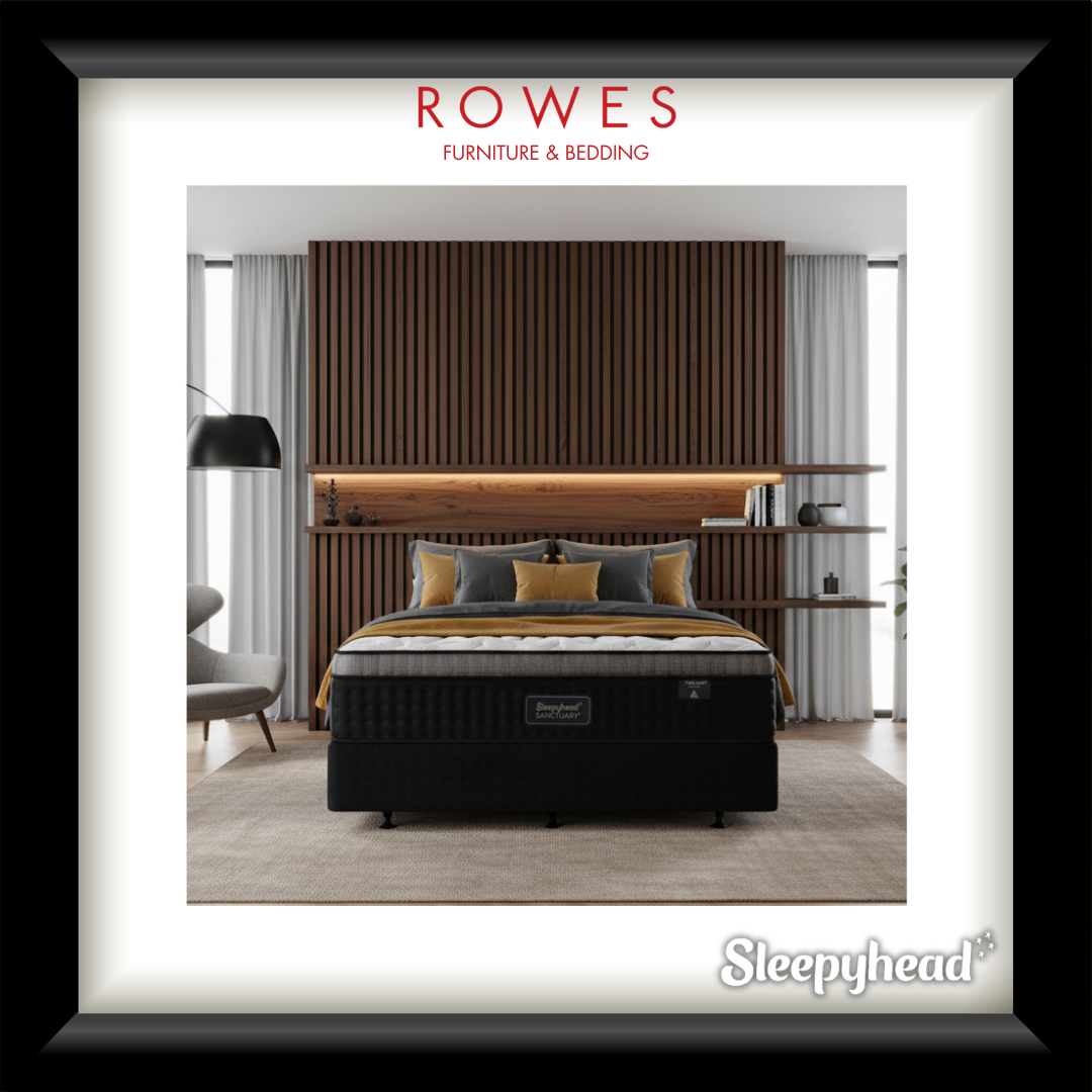 Bedroom setup with a black mattress, wooden headboard, and 'Sleepyhead' branding.