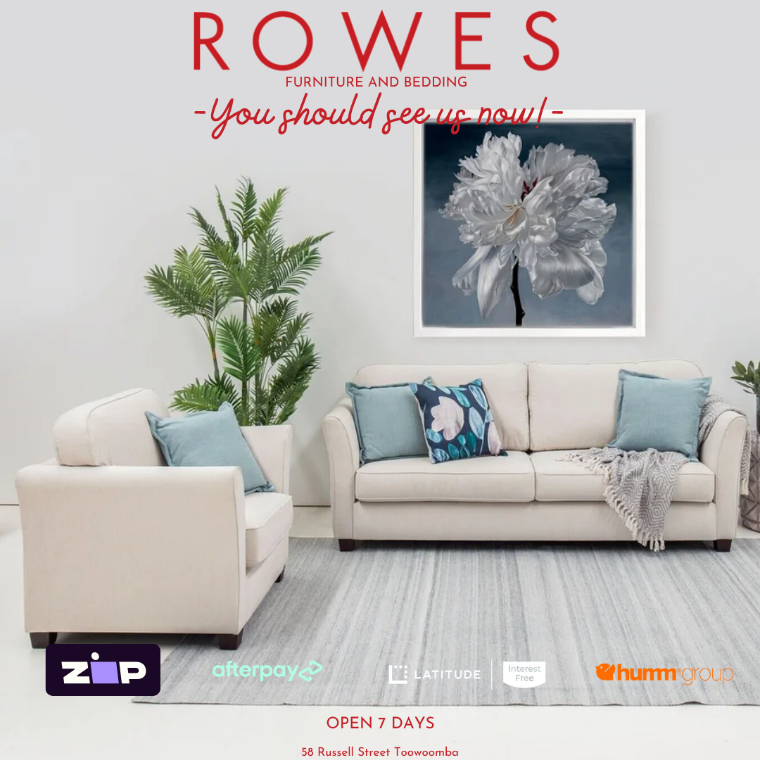 Living room with beige sofa, blue pillows, and a plant, featuring Rowes Furniture and Bedding advertisement.