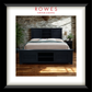 Dark wooden bed with white bedding in a room with stone wall and wooden floor, featuring 'Rowes Furniture & Bedding' logo.