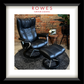 Black leather recliner chair with ottoman in front of a brick wall, featuring the Rowes Furniture & Bedding logo.