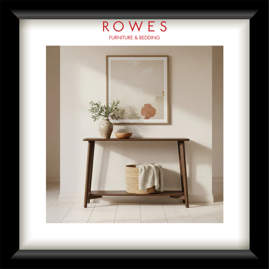 Framed interior design image with a wooden console table, mirror, and decor items, featuring the Rowes brand.